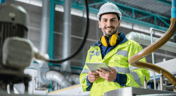 construction worker smiling at a treatment plant
